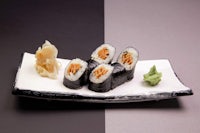 japanese sushi on a black and white plate