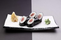 japanese sushi on a black and white plate