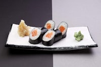 japanese sushi on a black and white plate