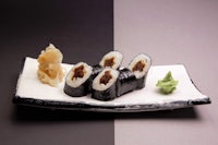 japanese sushi on a black and white plate