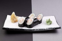 japanese sushi on a black and white plate